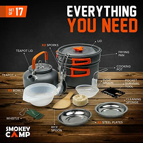 Camping cookware set with teapot, pots, pans, plates, and utensils.